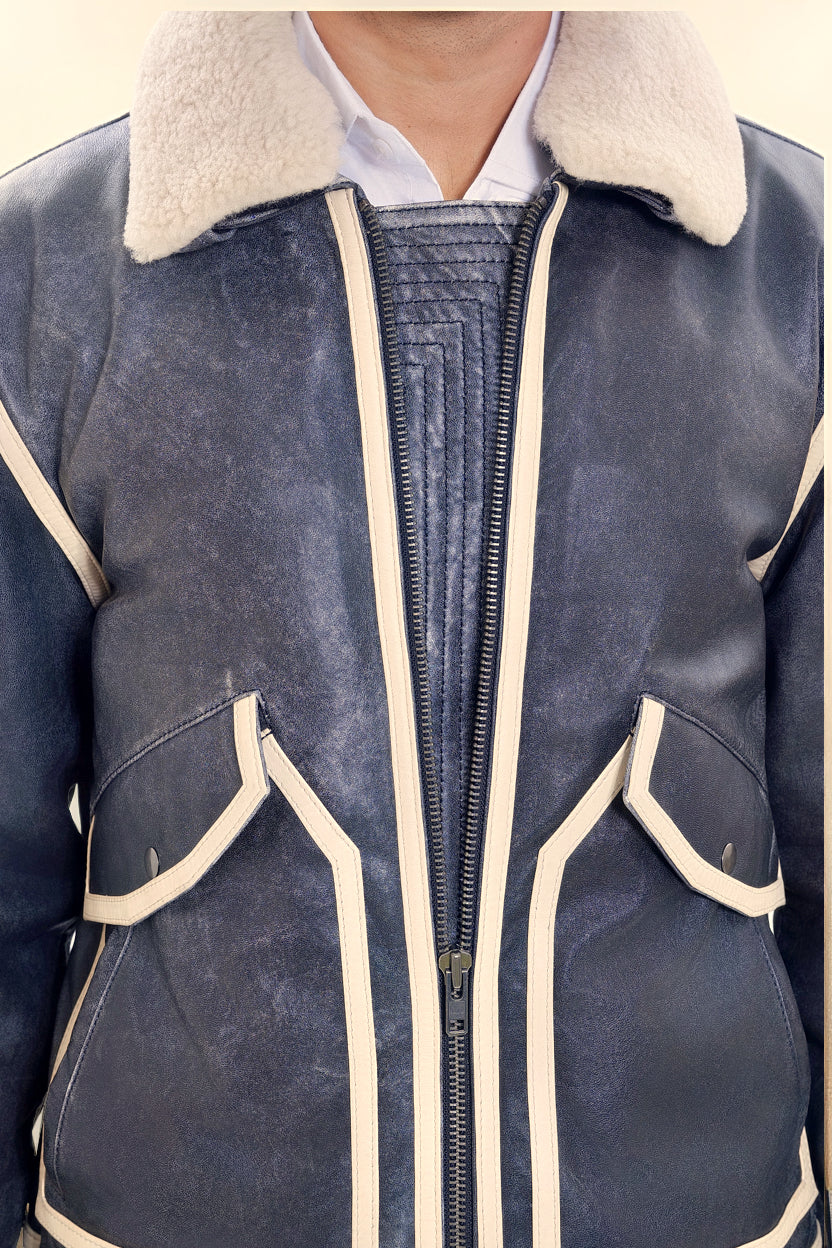 Male model detail shot, wearing our new Icarus style, a vintage-looking weathering grey colour flight jacket, 1/4 zipped showcasing stitched flap panel, off-white leather strips and body zipper.