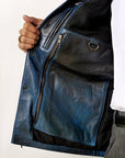 Male model detail shot, wearing our new Poseidon style, a two-tone black and blue chore jacket showcasing the 2 right side inner pockets along with a hanging loop and a D-ring.