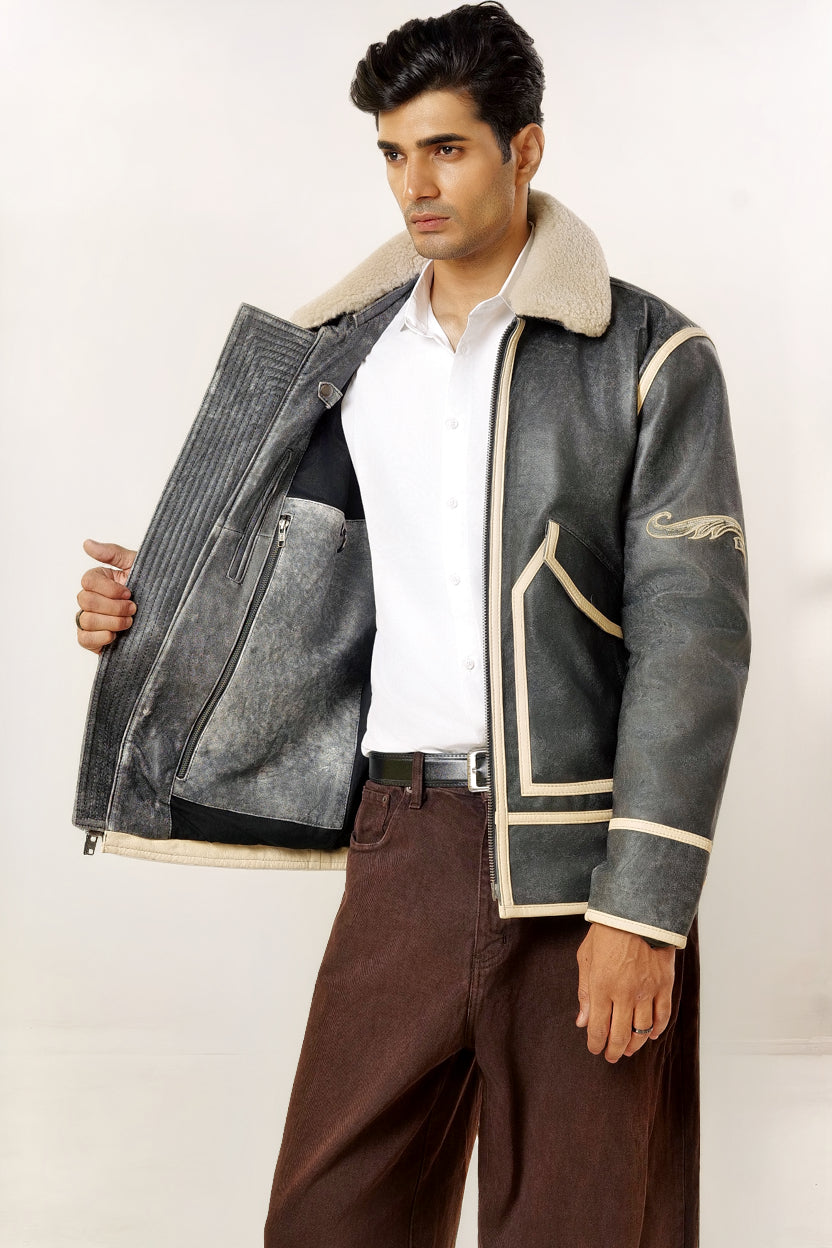 Male model half front shot, wearing our new Icarus style, a vintage-looking weathering grey colour flight jacket showcasing the 2 right side inner pockets along with a hanging loop and a D-ring.